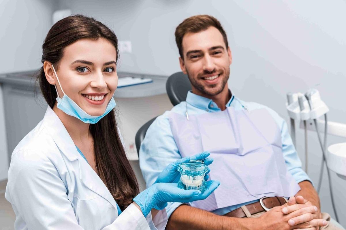 Orthodontist showing clear aligners to a patient during an orthodontic consultation